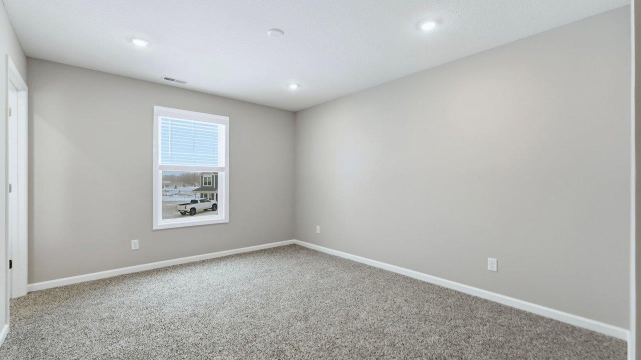 primary bedroom with ensuite closet and bathroom