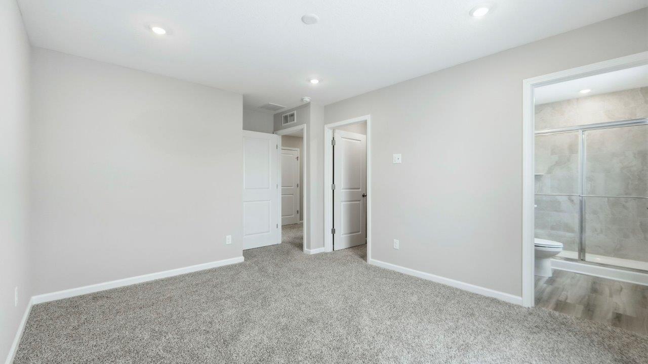 primary bedroom with ensuite closet and bathroom