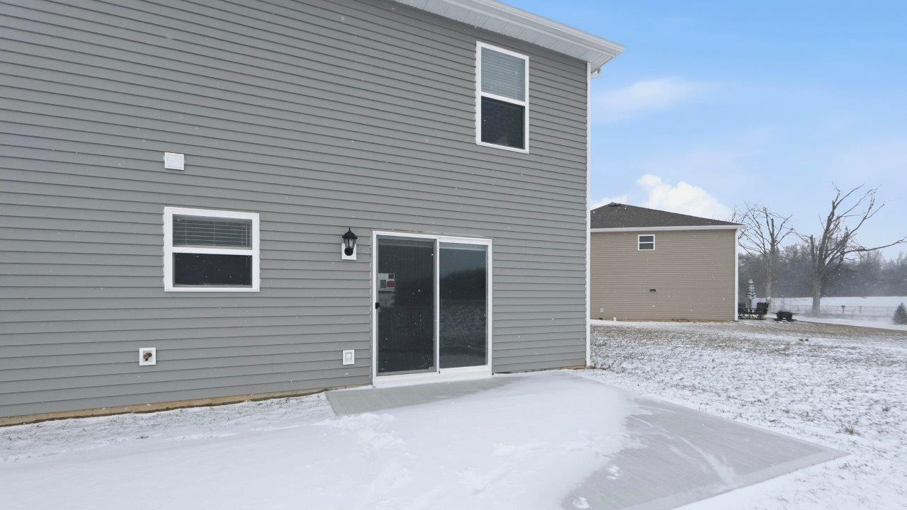 home rear exterior with concrete patio