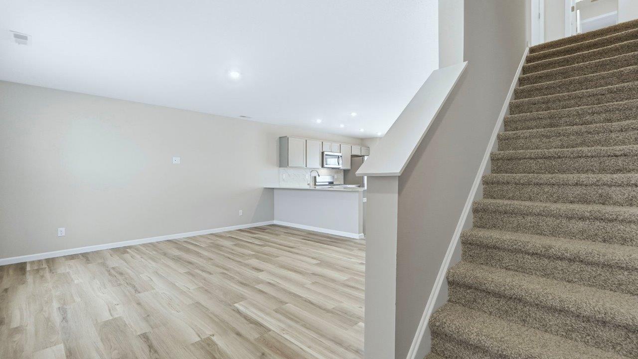 staircase to second floor with carpet flooring