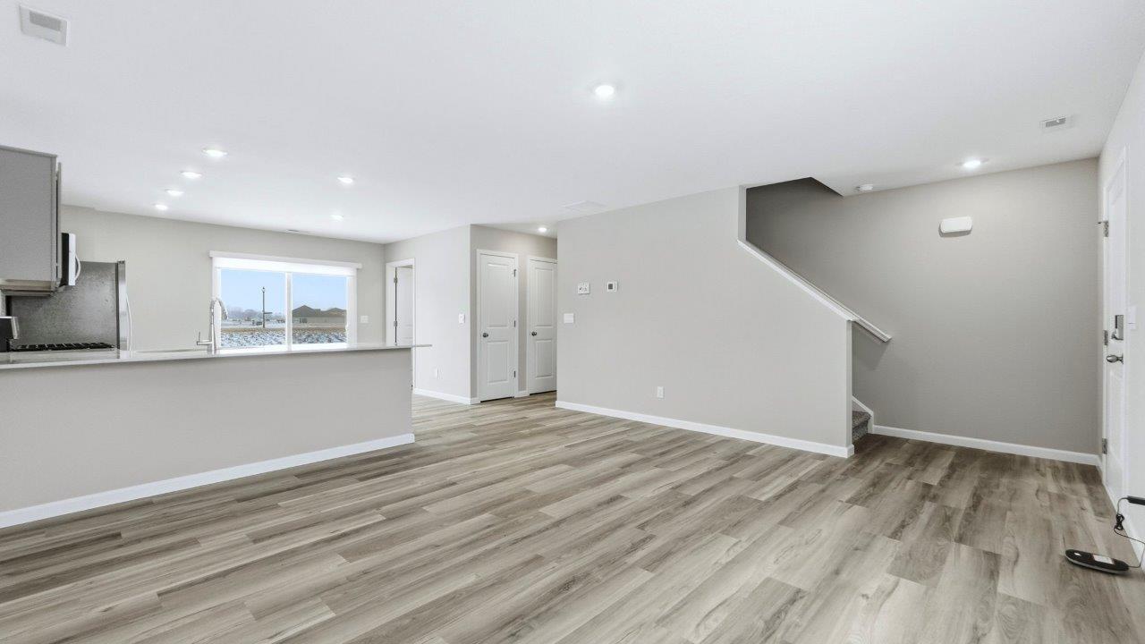 open layout living room, kitchen, and dining spaces