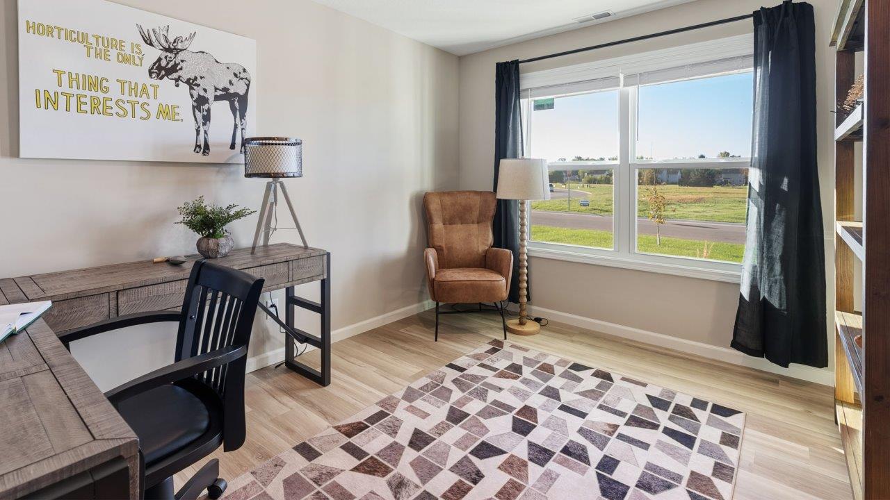 Greenbrier Stamford Model Home - study with mohawk avery lvp flooring, popular grey walls, and furnished as office