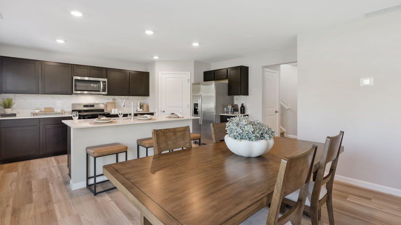 Greenbrier Stamford Model Home - open layout casual dining room and kitchen with mohawk avery lvp flooring