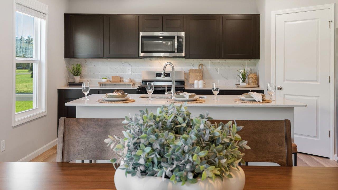 Greenbrier Stamford Model Home - sarsaparilla cabinets, lyra quartz countertops, stainless steel appliances, center island, and corner pantry