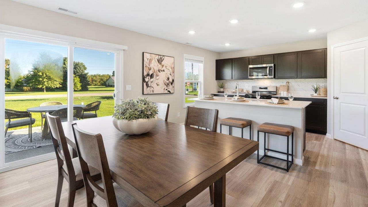 Greenbrier Stamford Model Home - casual dining room with mohawk avery lvp flooring and sliding glass door to backyard