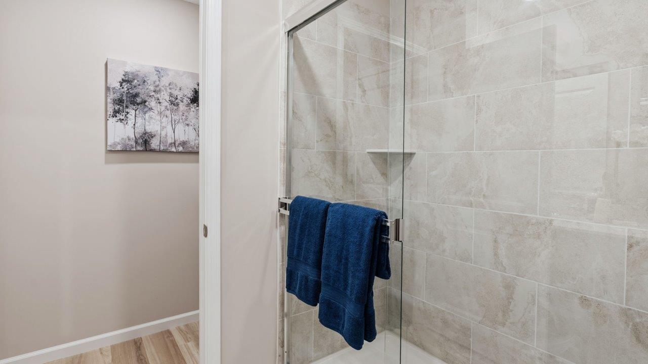 Greenbrier Stamford Model Home - primary bedroom ensuite bathromo with dual sink vanity, quartz countertops, walk in tile shower