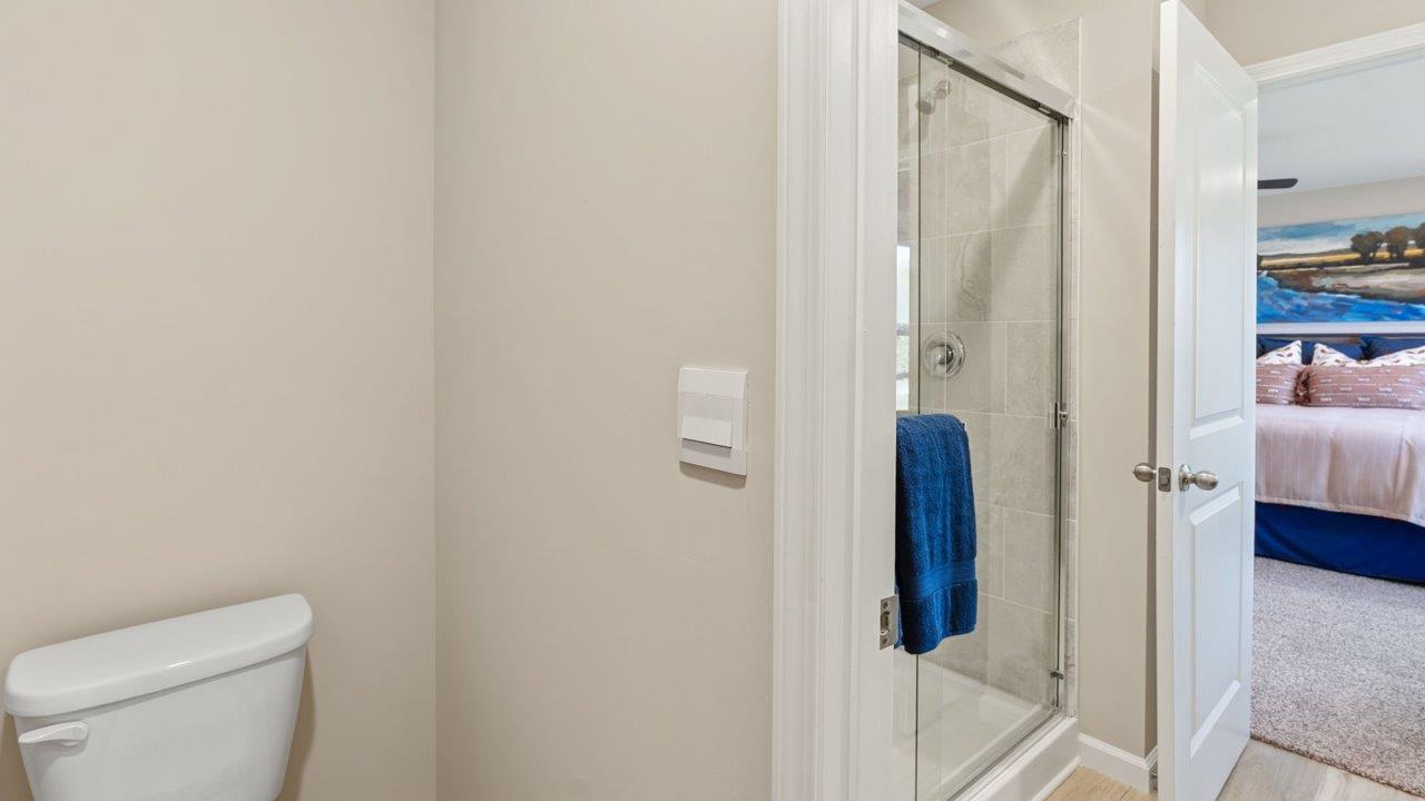 Greenbrier Stamford Model Home - primary bedroom ensuite bathromo with dual sink vanity, quartz countertops, walk in tile shower