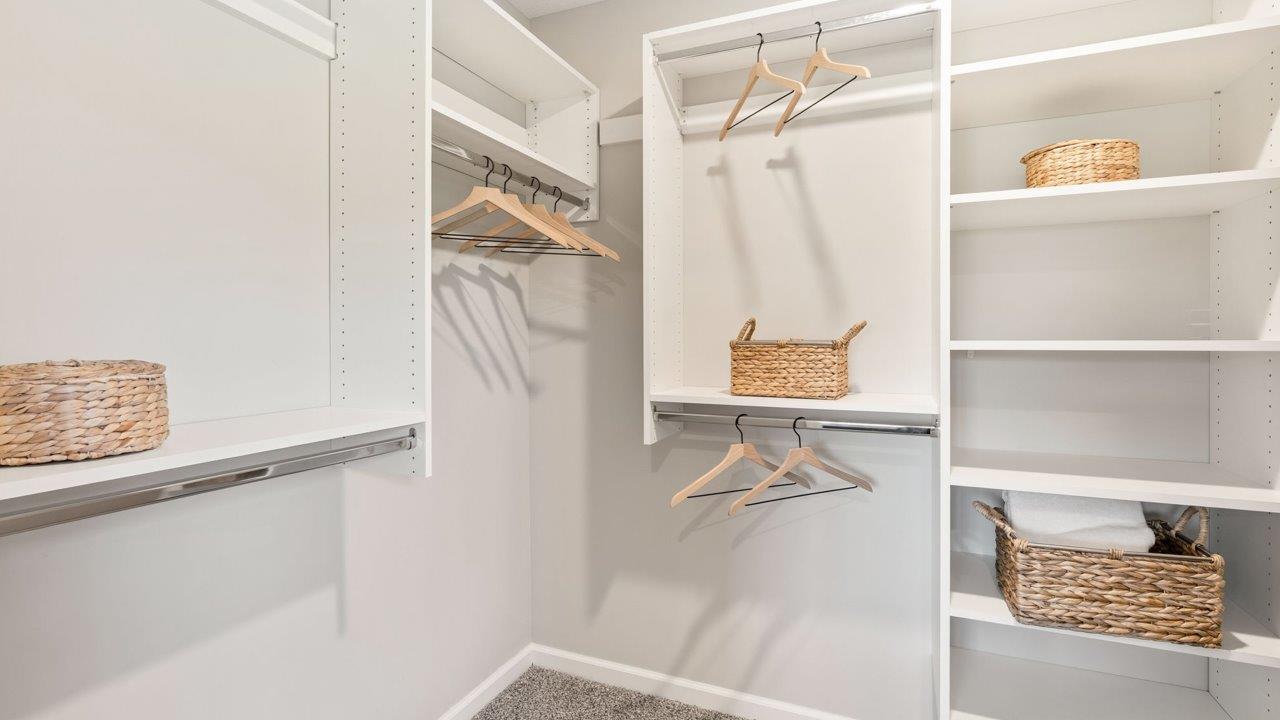 Greenbrier Stamford Model Home - primary bedroom ensuite walk in closet with built in shelving system