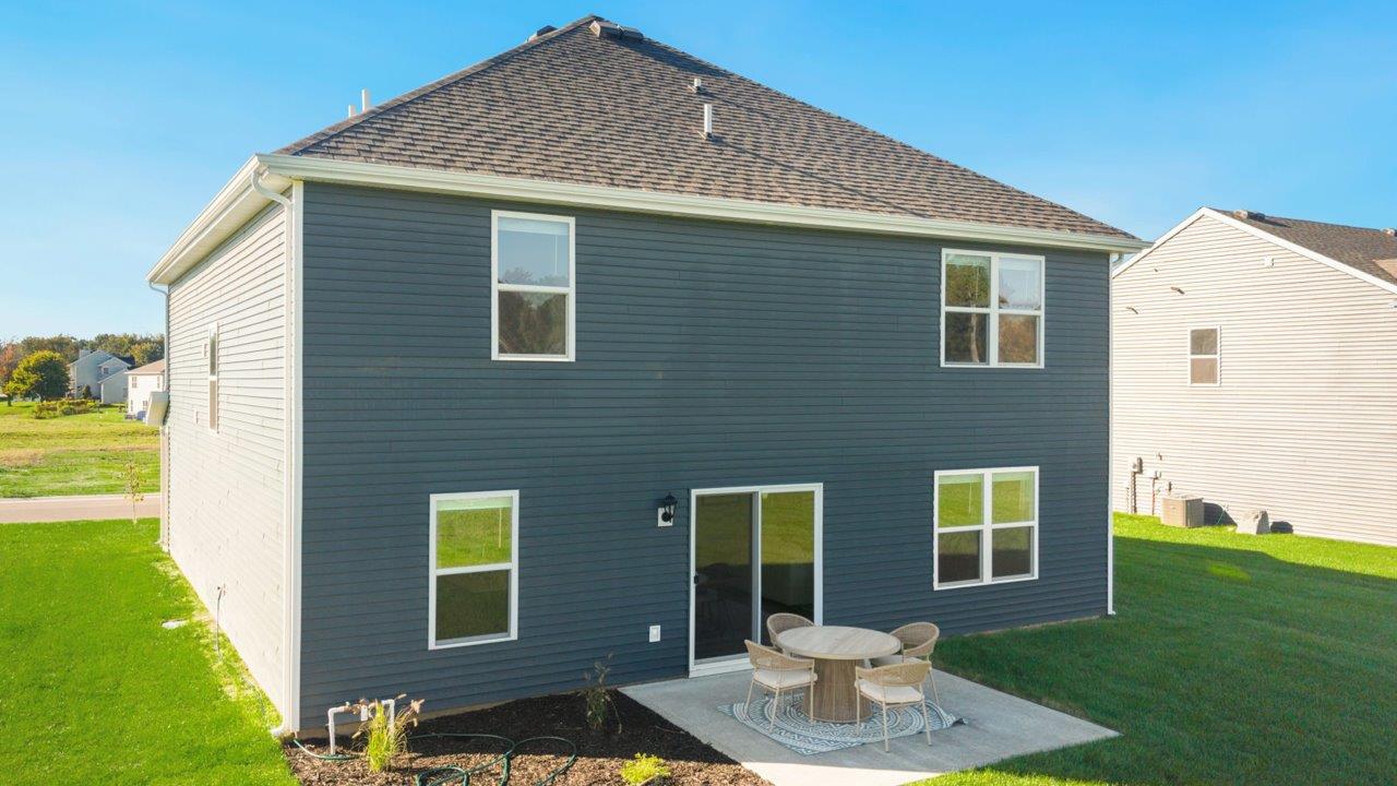 Greenbrier Stamford Model Home - rear exterior with sod backyard and concrete patio