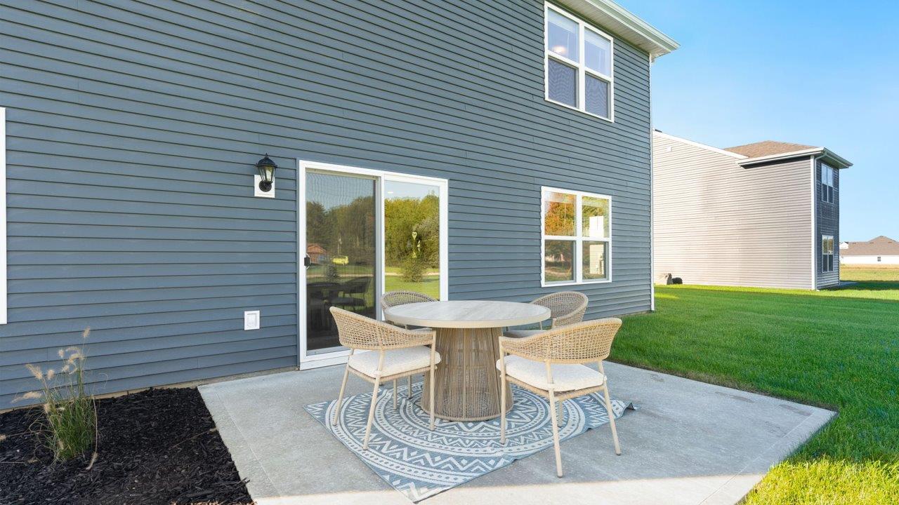 Greenbrier Stamford Model Home - rear exterior with sod backyard and concrete patio