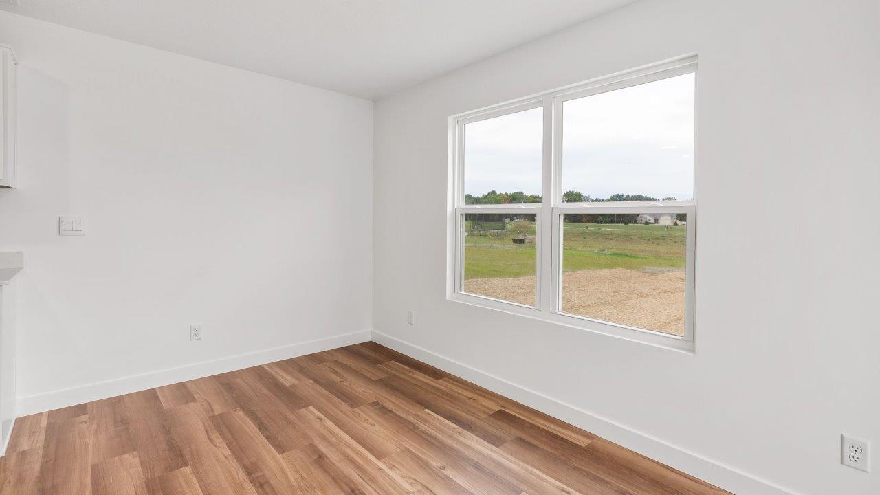 greenbrier cabral casual dining room with lvp flooring and sliding glass door to backyard patio