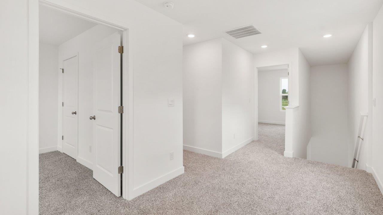 greenbrier cabral second floor landing with elk biege carpet flooring and white walls