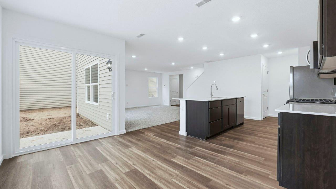 dining room with lvp and sliding door to backyard patio