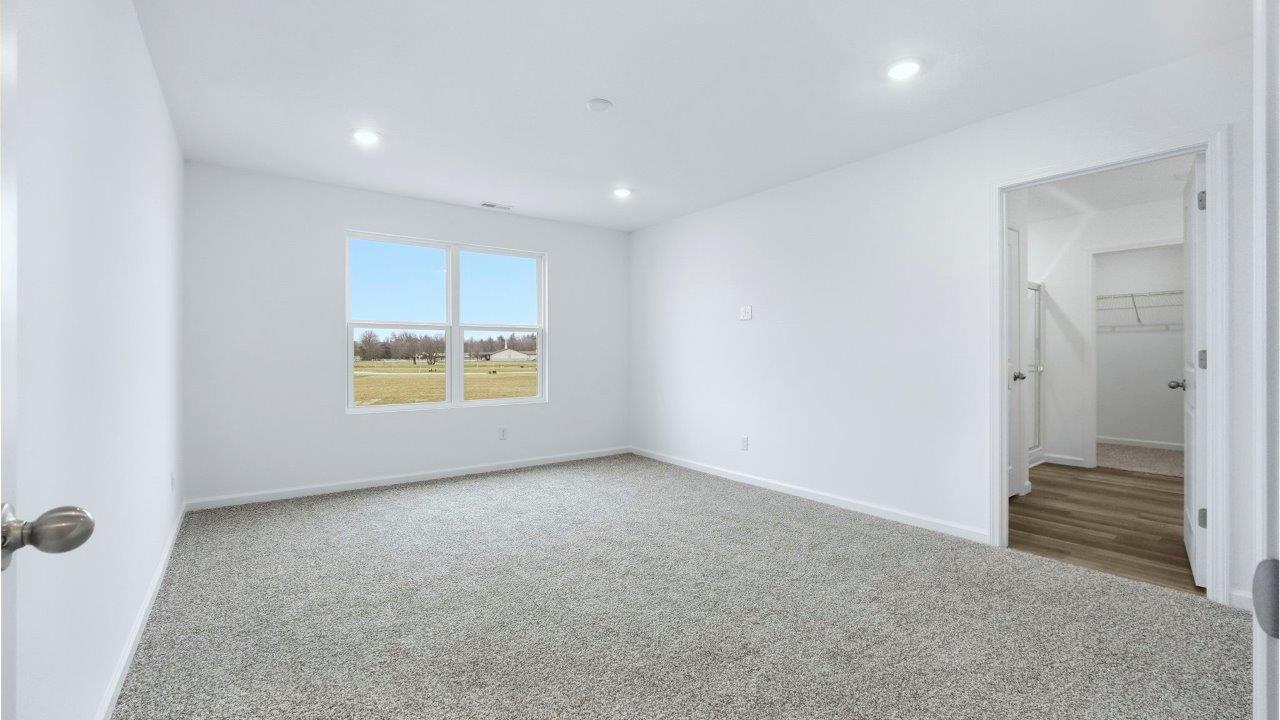 primary bedroom with carpet flooring