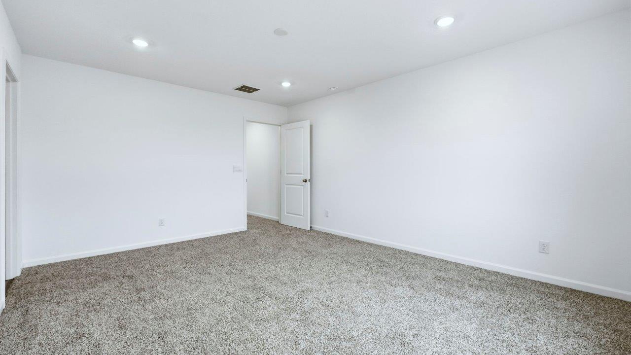 primary bedroom with carpet flooring