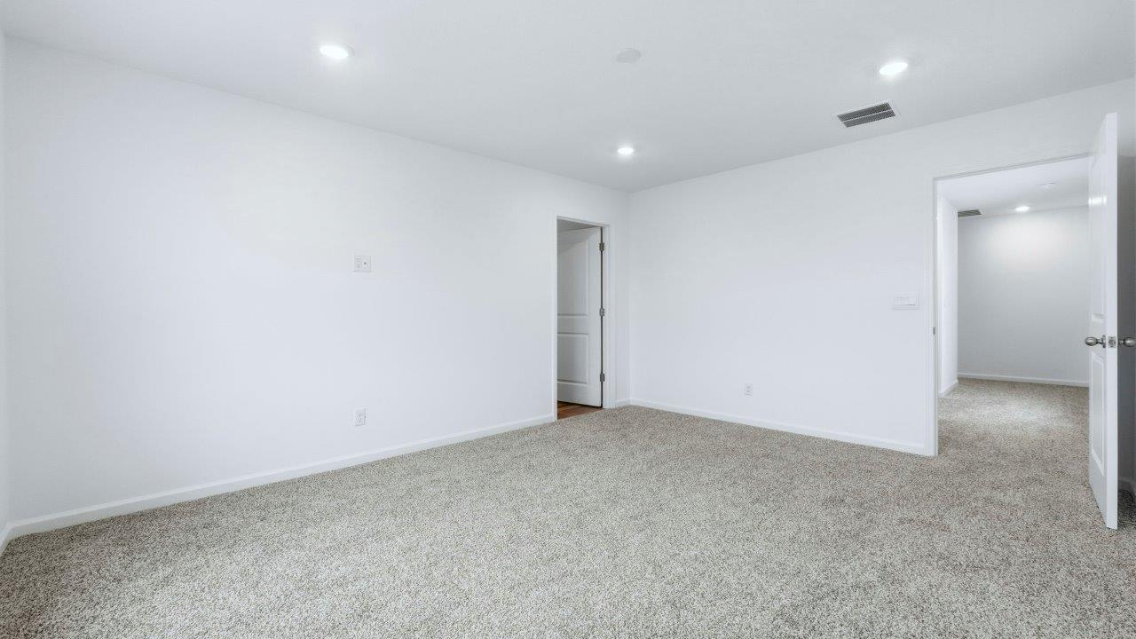 primary bedroom with carpet flooring