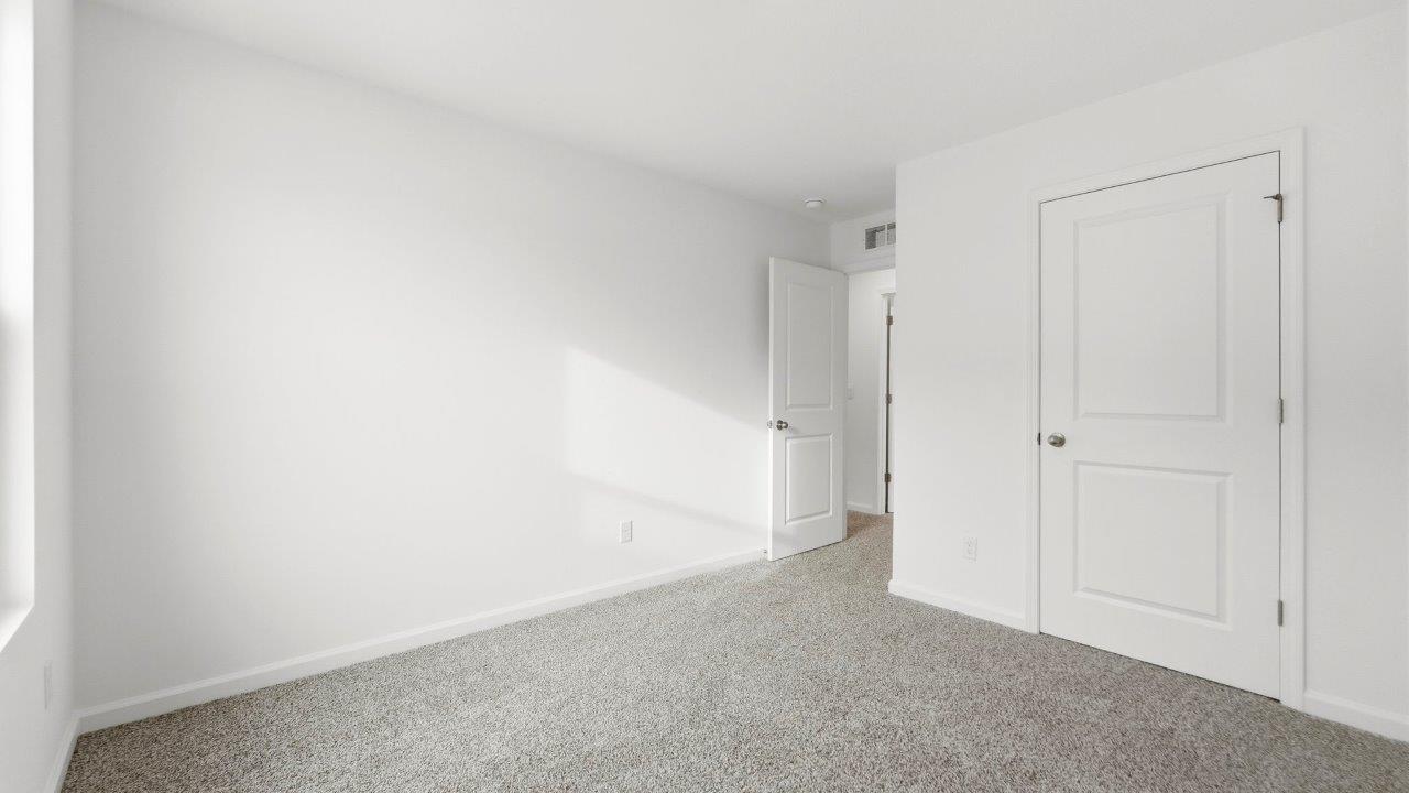 bedroom 3 with carpet and closet