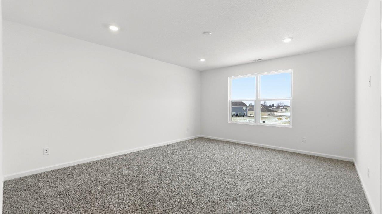 primary bedroom with carpet and ensuite bath and closet