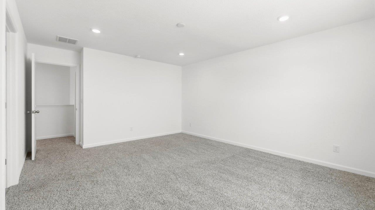 primary bedroom with carpet and ensuite bath and closetprimary bedroom with carpet and ensuite bath and closet