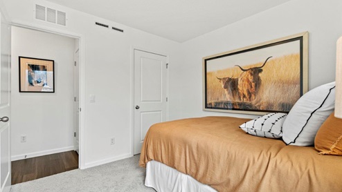 Riverwalk Aldridge model home - bedroom 3 with on suite closet and carpet flooring