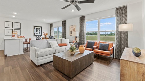 Riverwalk Aldridge model home - living room with 2 large windows to let in natural light.