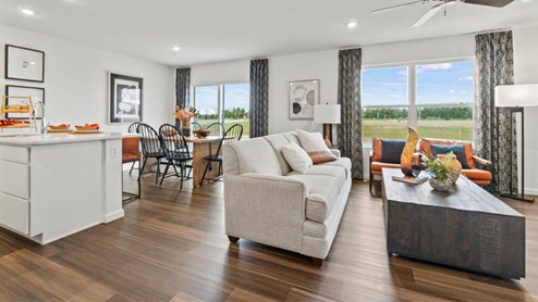 Riverwalk Aldridge model home - open floor plan living room, kitchen, and dining room