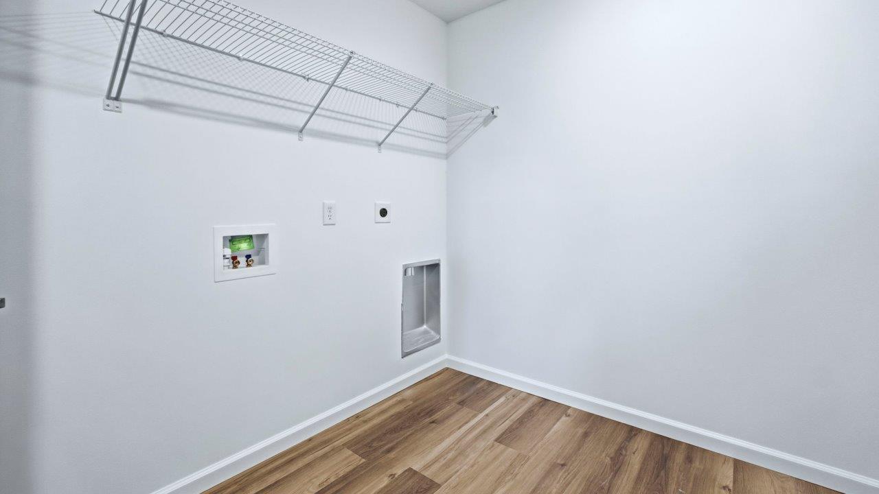 laundry room with hookups, lvp, and shelving
