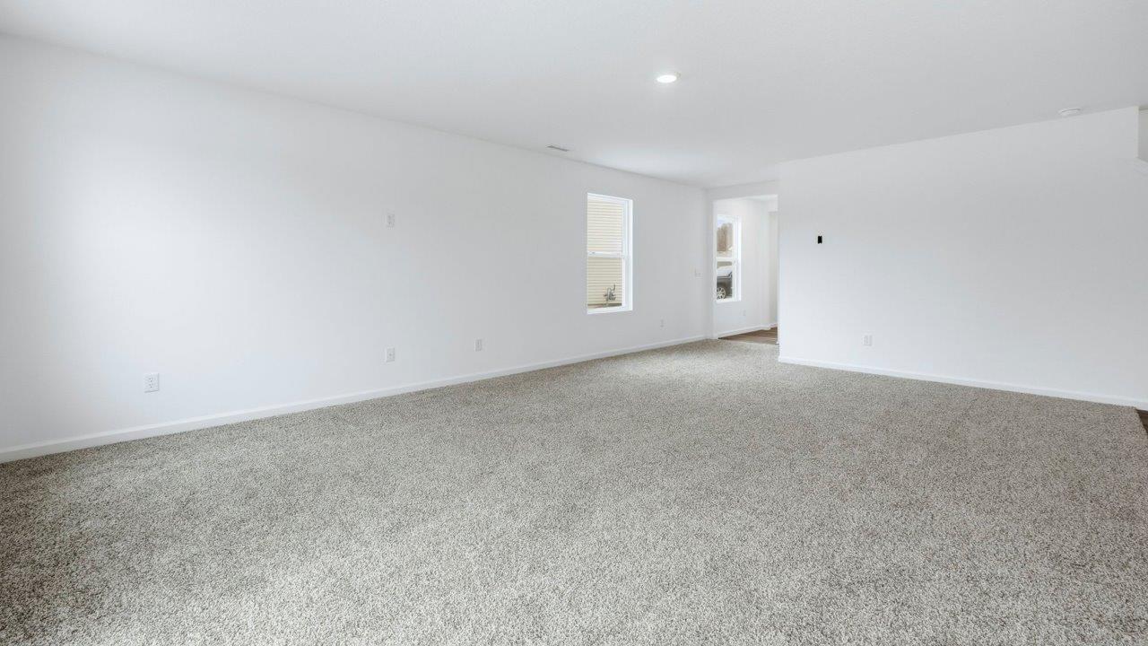 open floor plan living room with carpet flooring