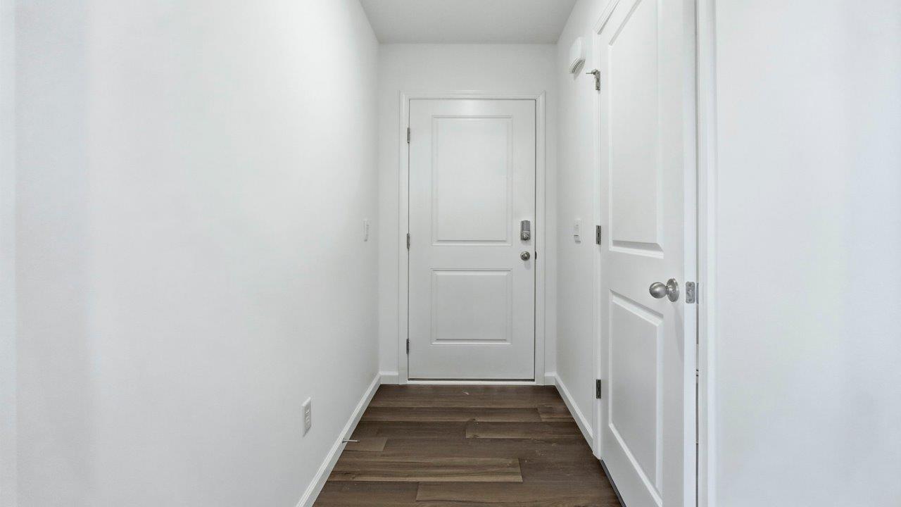 front door and main hallway with lvp flooring