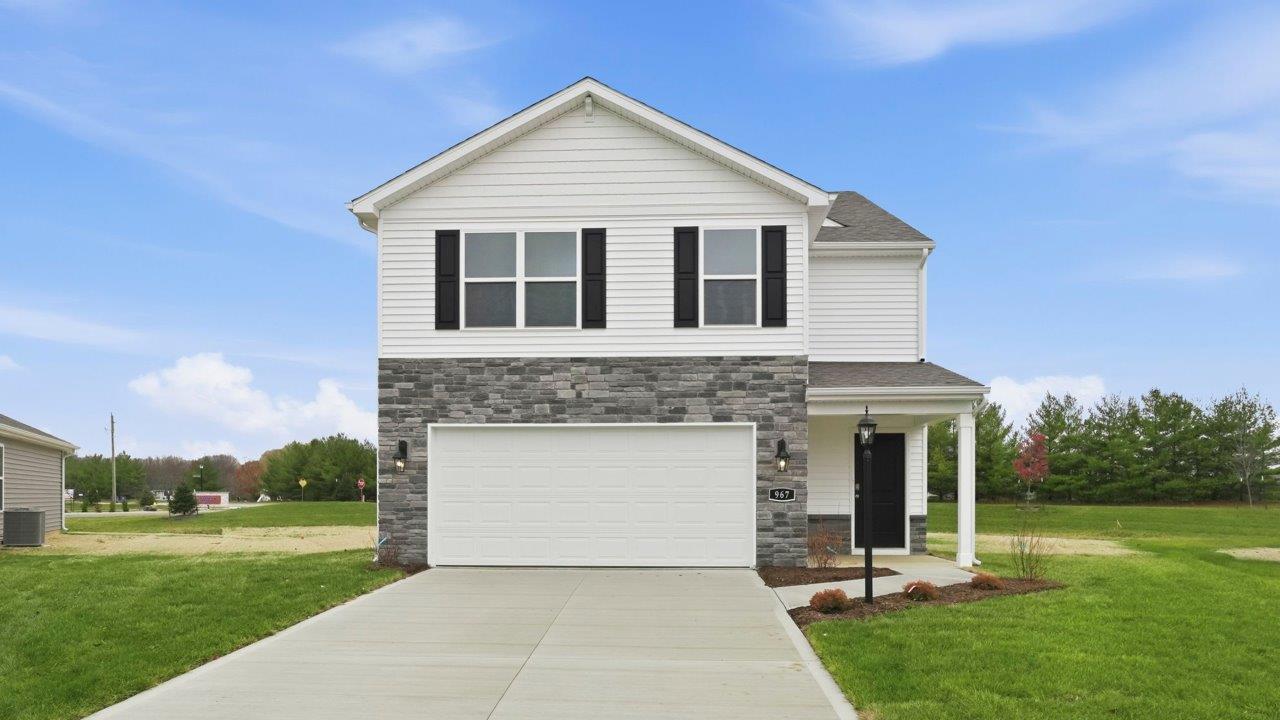 riverwalk elder 2 story home with front patio, sod, and landscaping