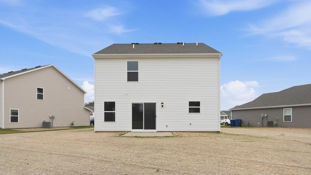 elder backyard and uncovered patio with seeded yard