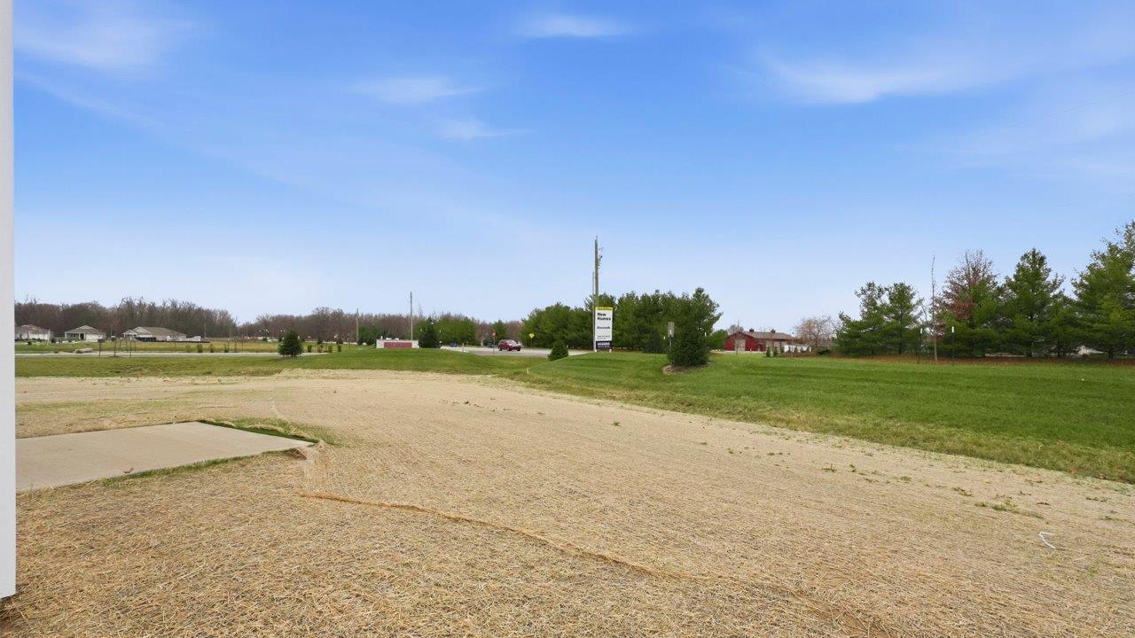 elder backyard and uncovered patio with seeded yard
