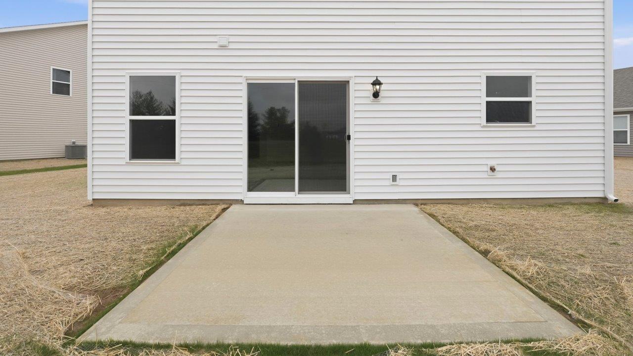 elder backyard and uncovered patio with seeded yard