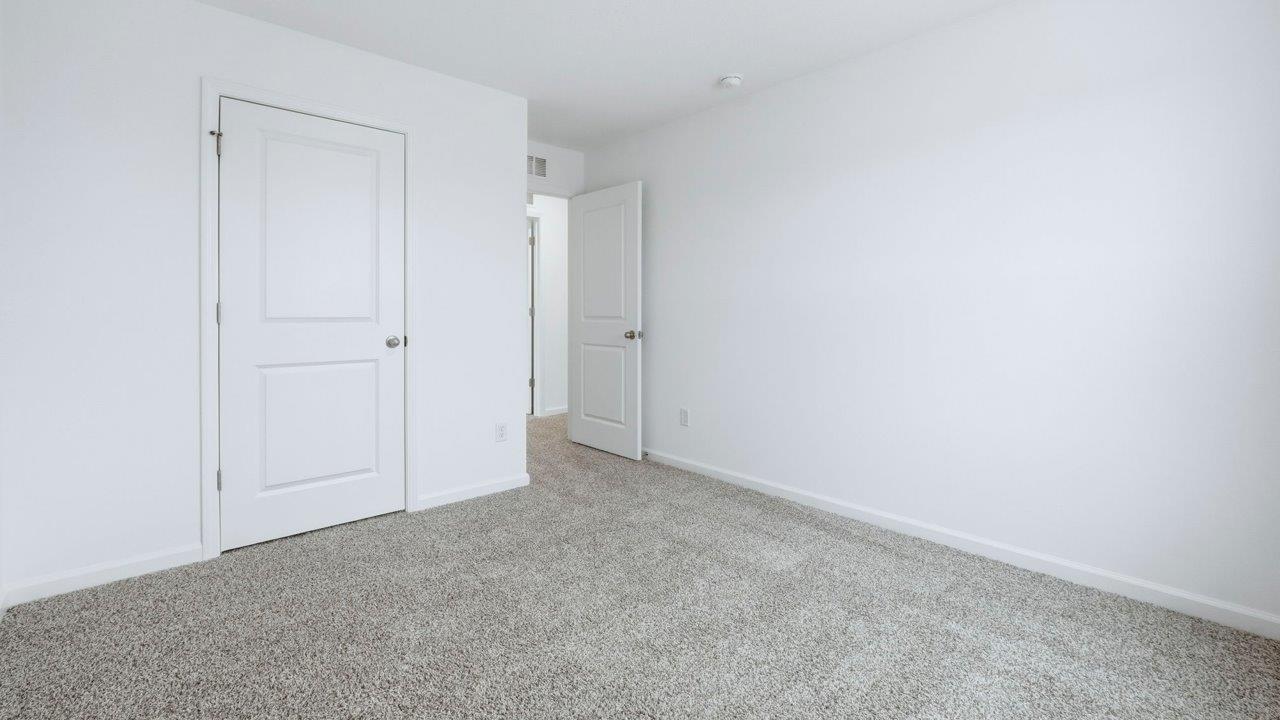 bedroom 2 with carpet and closet