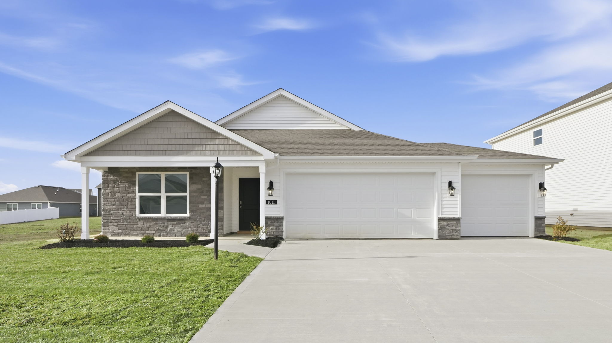 riverwalk chatham exterior with covered front porch and 3 car garage