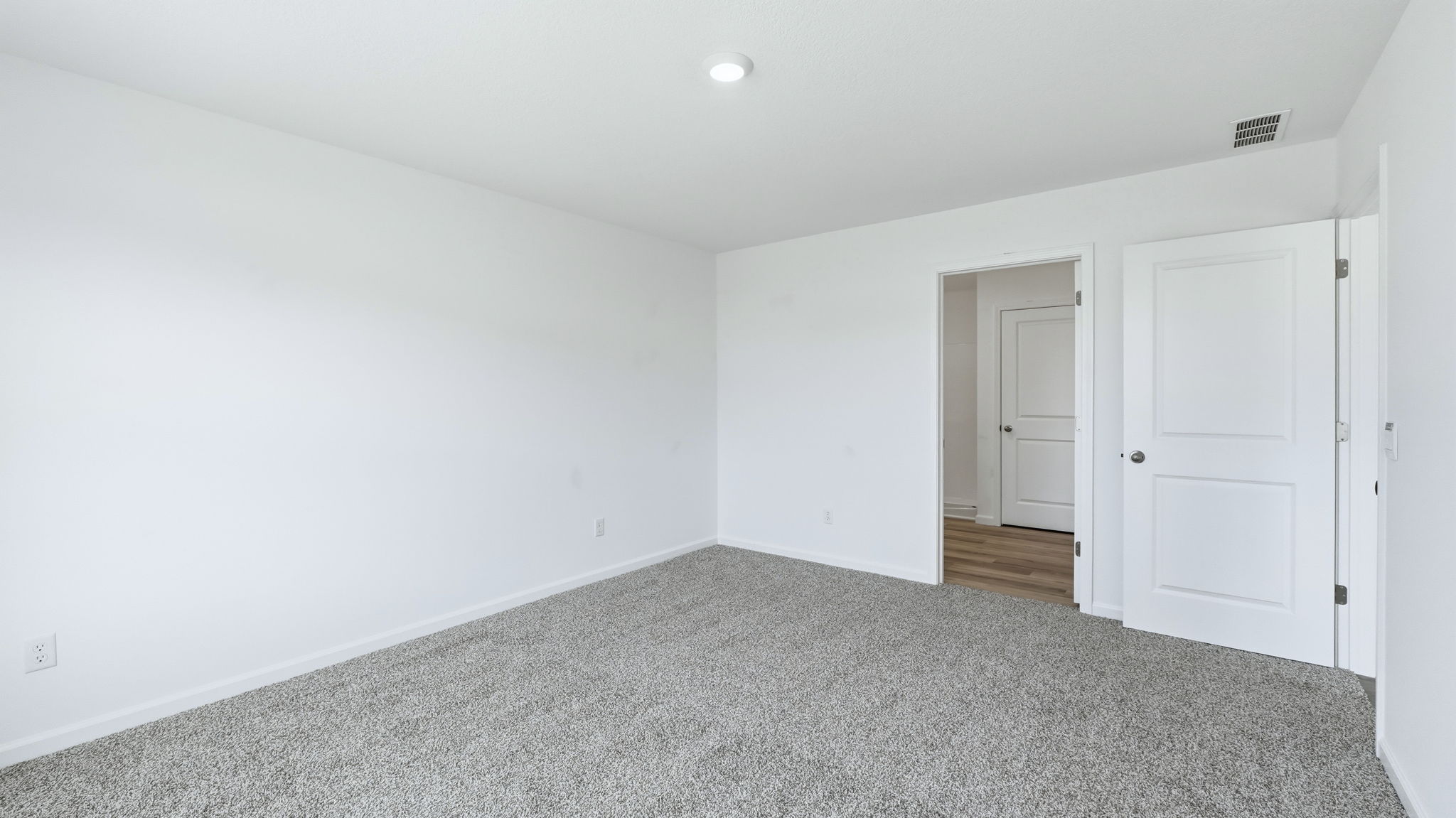 primary bedroom with ensuite bath and closet
