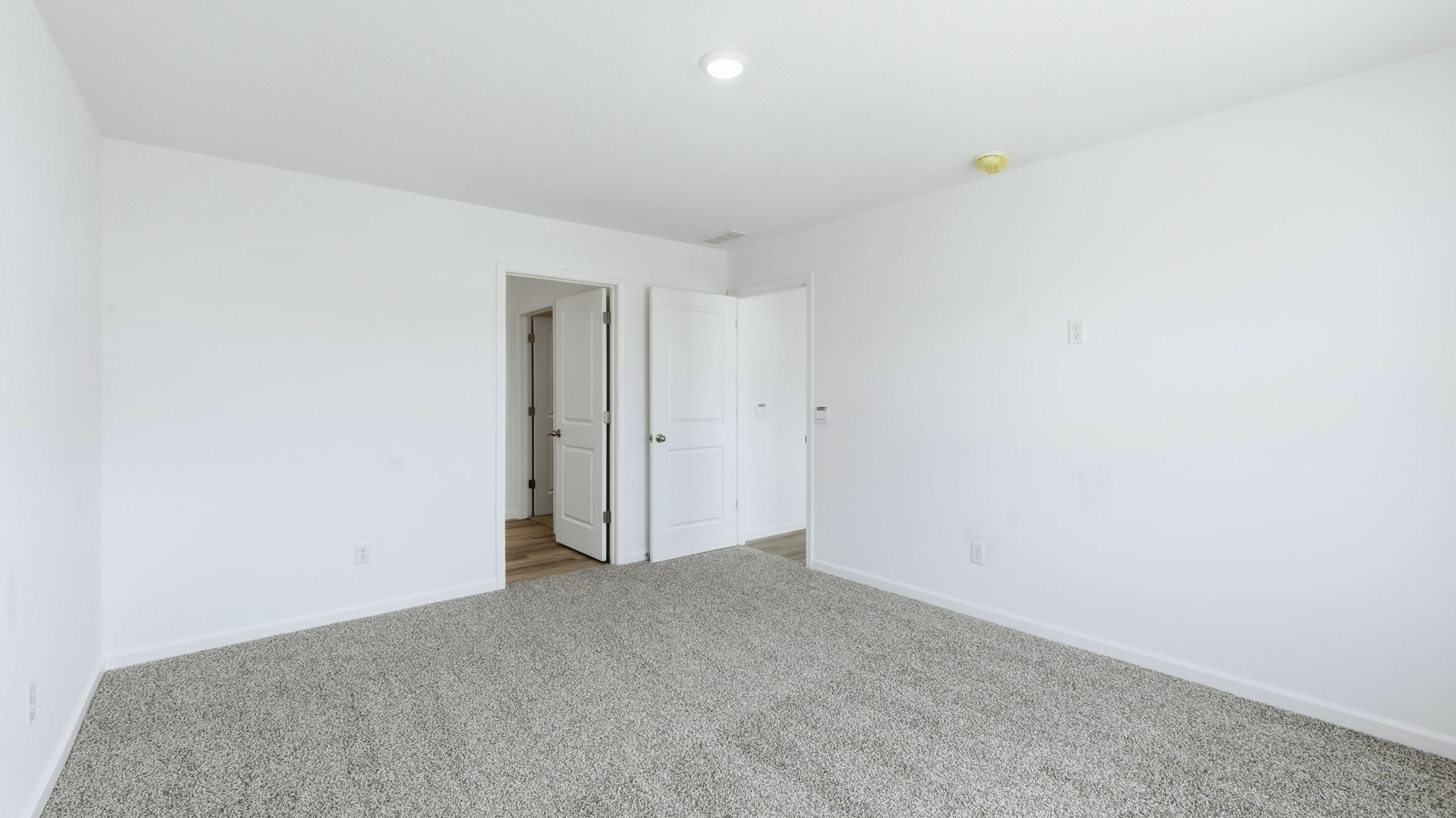 primary bedroom with ensuite bath and closet
