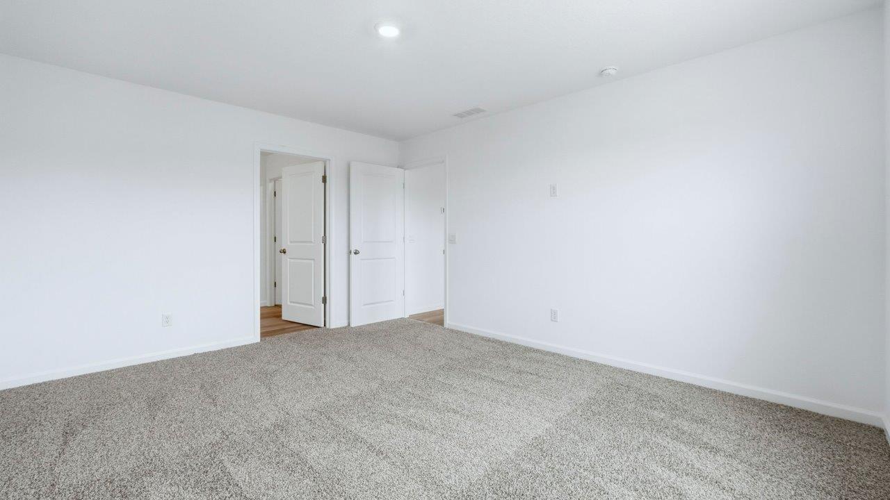 primary bedroom with ensuite bath and closet