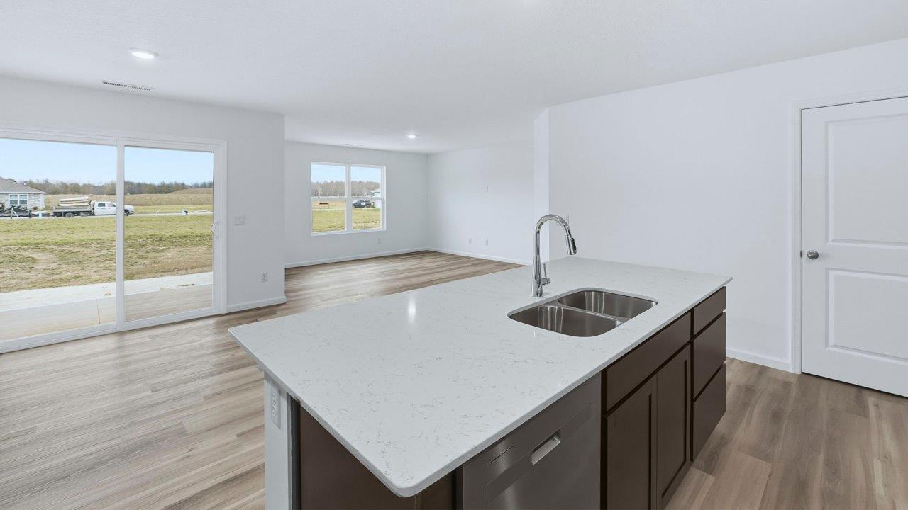 kitchen and dining open layout with lvp and sliding door to backyard covered patio