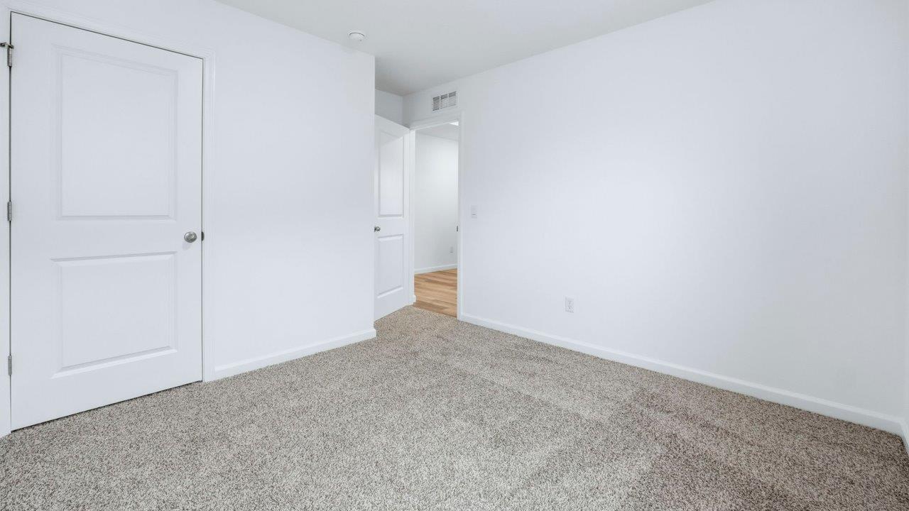 bedroom 3 with carpet and closet