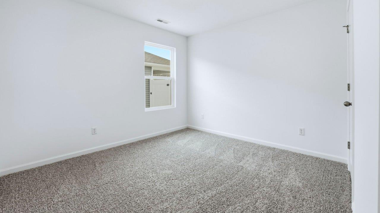bedroom 3 with carpet and closet