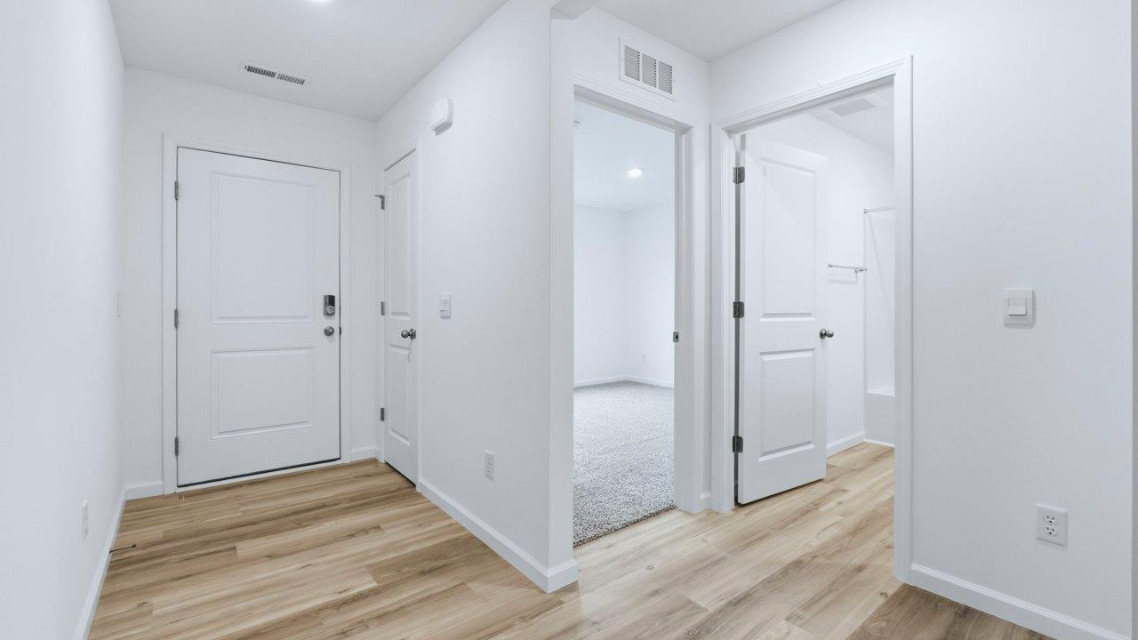 front door and main hallway with lvp flooring