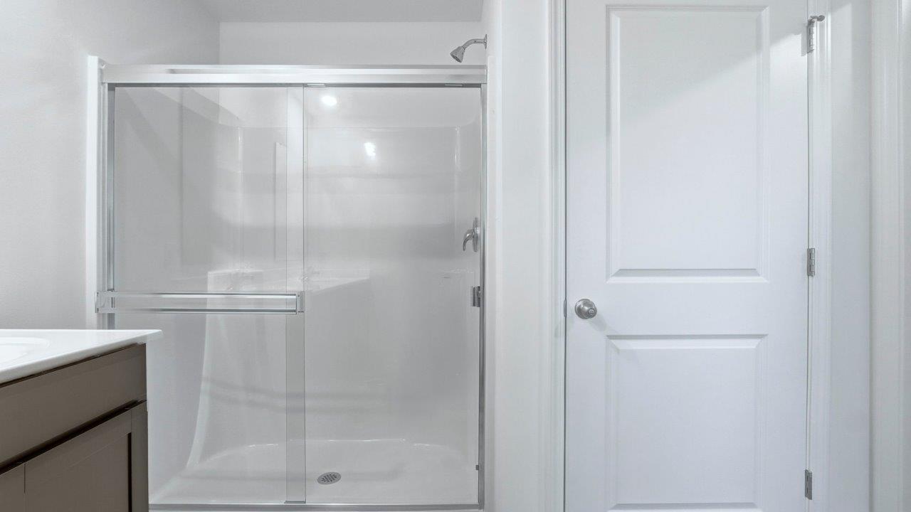 primary ensuite bathroom with dual sinks, walk in shower, and private water room