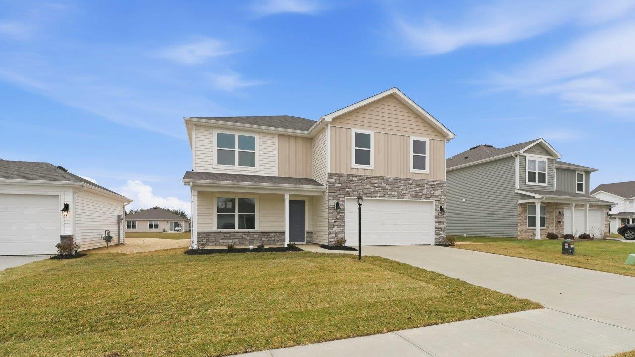 riverwalk henley exterior with 2 car garage, landscaping, and large covered front porch