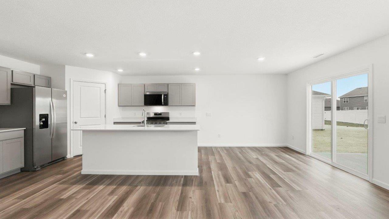 open plan kitchen and dining room with lvp floors