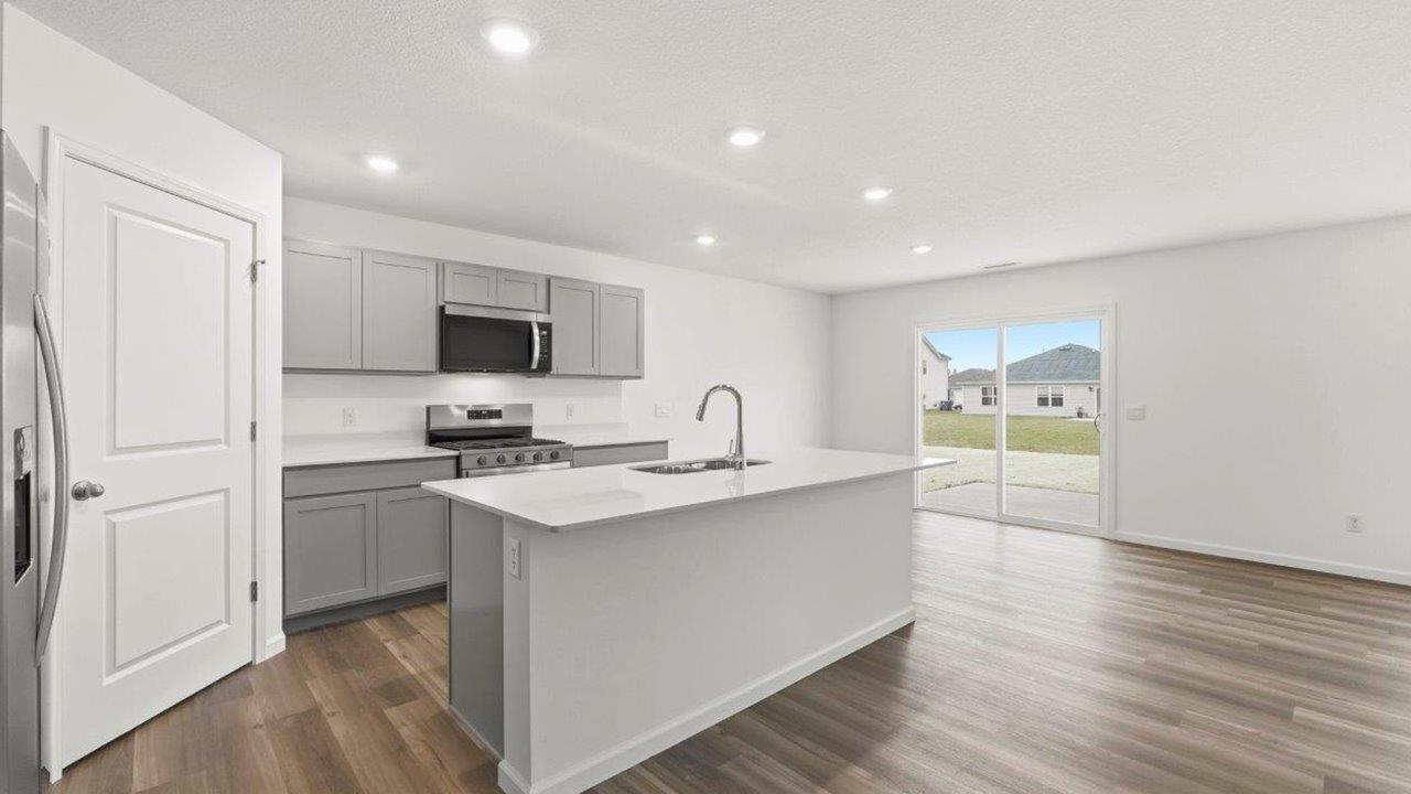 open plan kitchen and dining room with lvp floors
