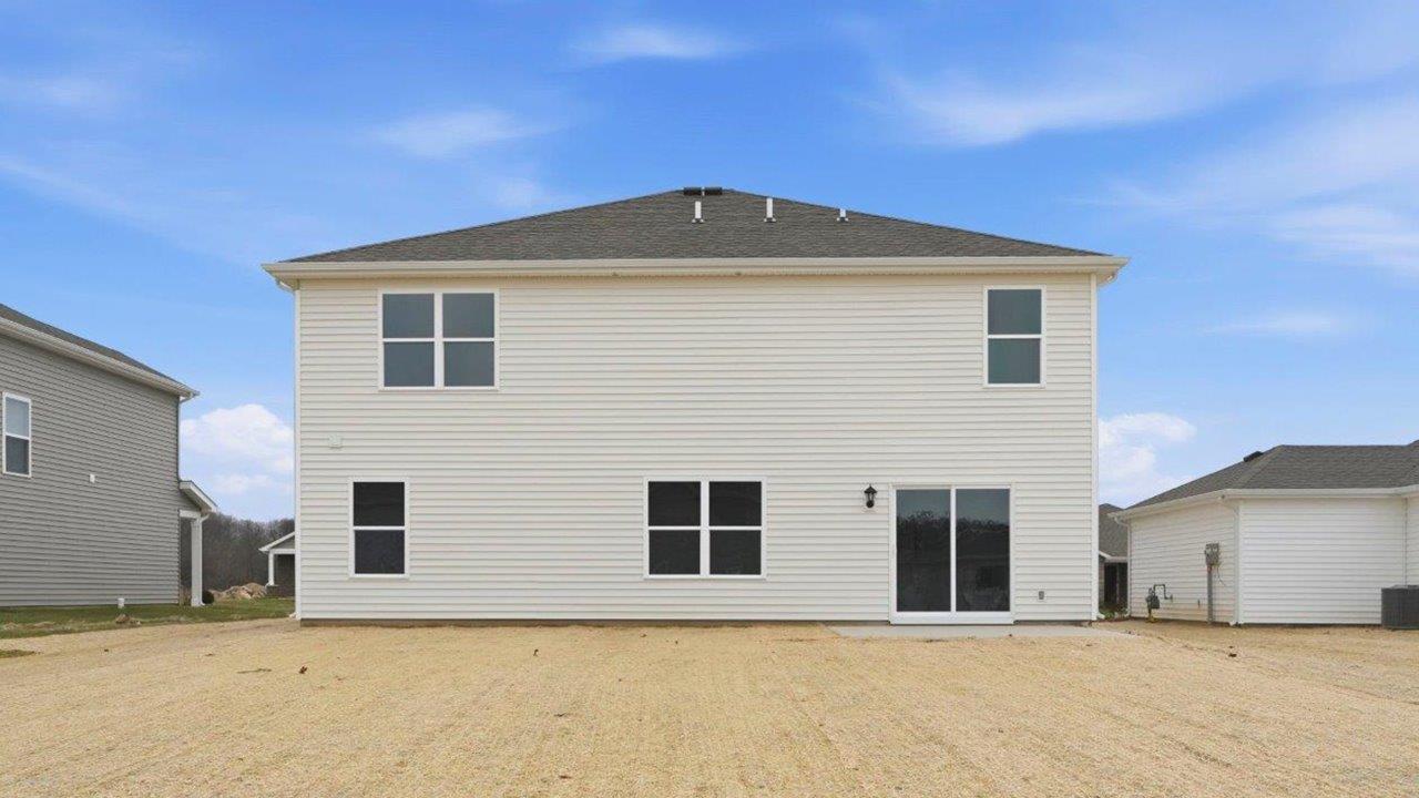 rear exterior with large backyard and concrete patio