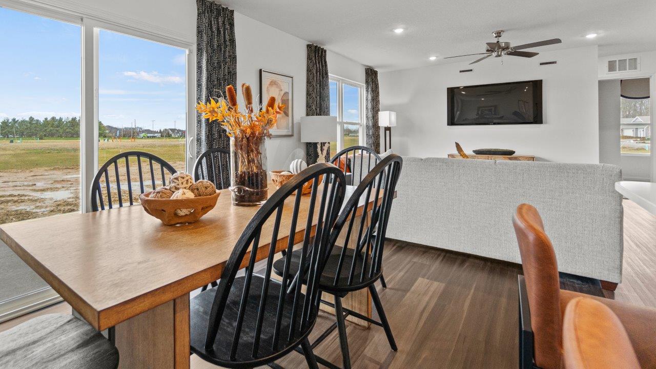 riverwalk aldridge model casual dining room with ryder lvp flooring and sliding glass door to backyard