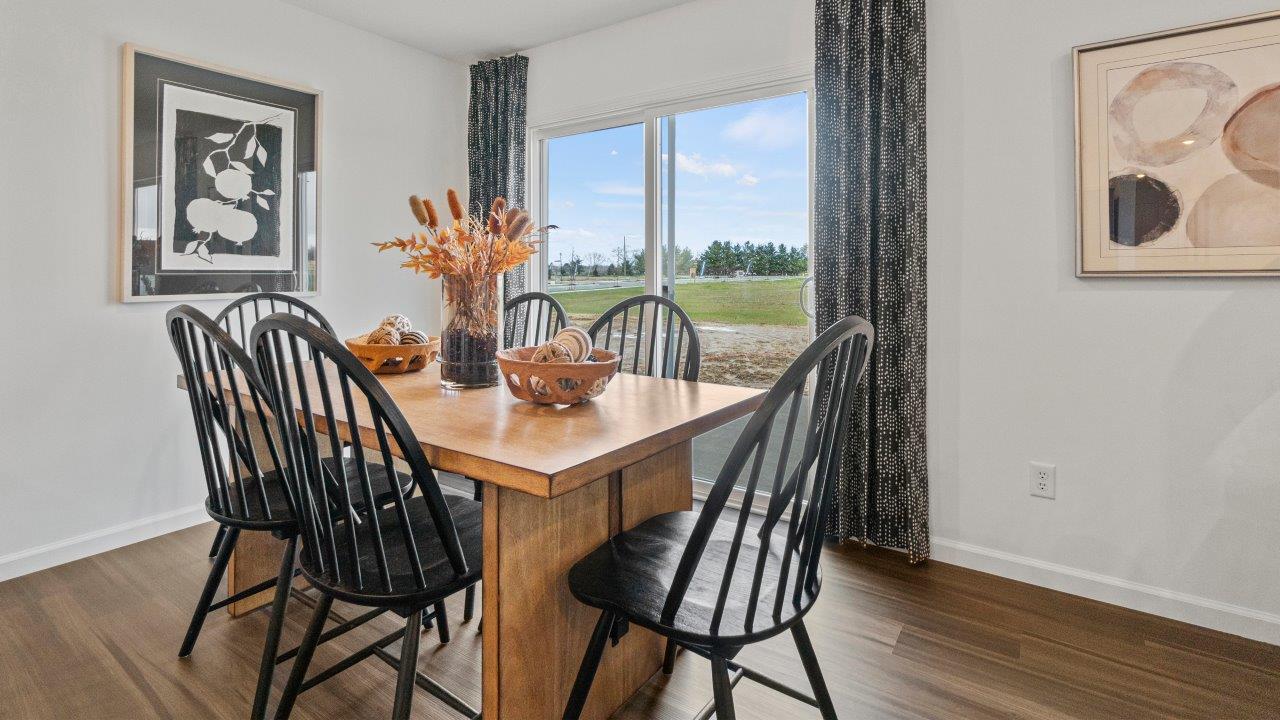riverwalk aldridge model casual dining room with ryder lvp flooring and sliding glass door to backyard