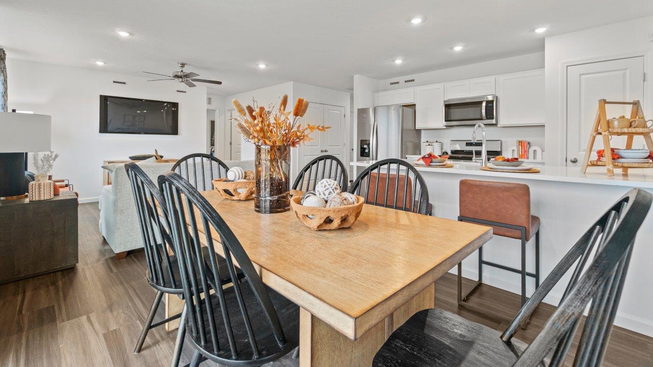 riverwalk aldridge model casual dining room with ryder lvp flooring and sliding glass door to backyard